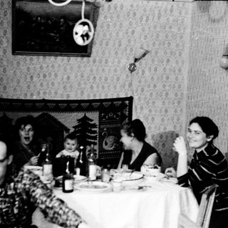 Family gathering at festive holiday table.