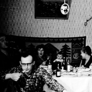 Family gathering at festive holiday table.