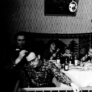 Family gathering at a table during a meal.