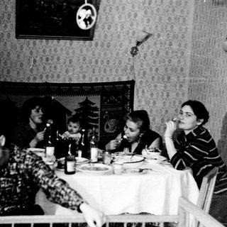 Family gathering at a table during a meal.