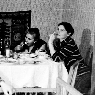 Family gathering at a table during a meal.