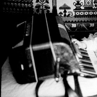 Baby playing with toy piano indoors.