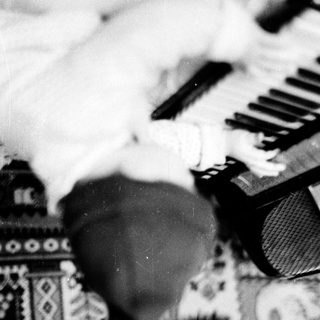 A person playing a piano with a blurred background.