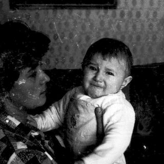 A child crying while being held indoors.