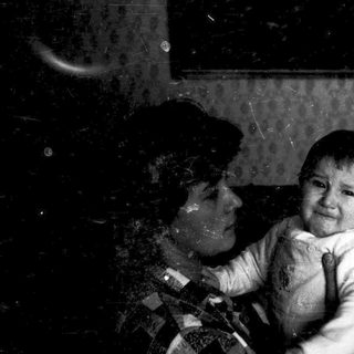A child crying while being held indoors.