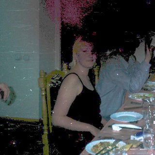People dining indoors with dim lighting and confetti.