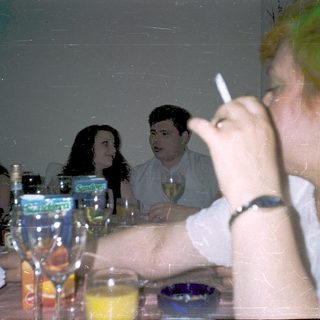 People gathered indoors, drinking and socializing.