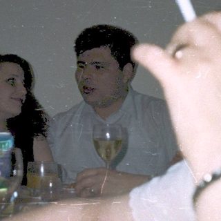 People gathered indoors, drinking and socializing.
