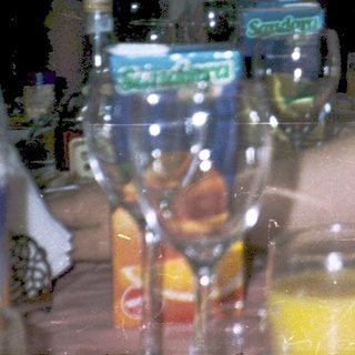 People gathered indoors, drinking and socializing.