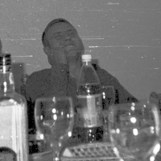 Celebratory gathering with people drinking champagne indoors.