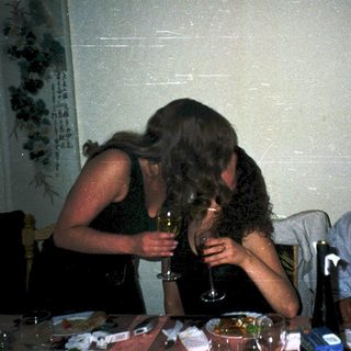 Three people at a celebratory table, one toasting another.