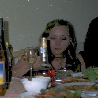 Group enjoying meal and drinks indoors.