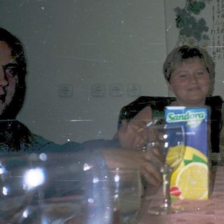 Group enjoying meal and drinks indoors.