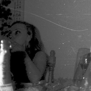 People toasting with drinks at a social gathering.