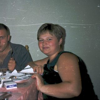 Three people enjoying drinks at a casual indoor gathering.