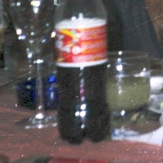 Three people enjoying drinks at a casual indoor gathering.