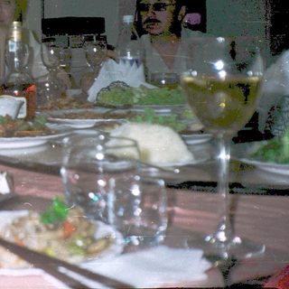Group of people dressed in costumes at a dinner table.