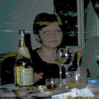 Group of people dressed in costumes at a dinner table.