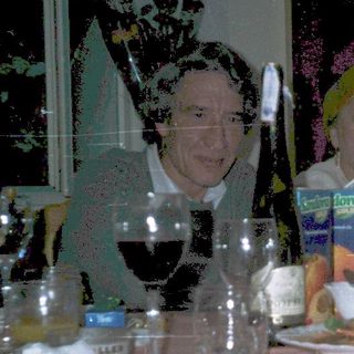 Group of people dressed in costumes at a dinner table.