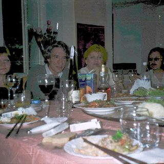 Group of people dressed in costumes at a dinner table.