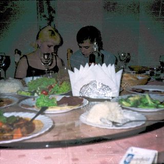 Family dining on diverse meal at festive table.