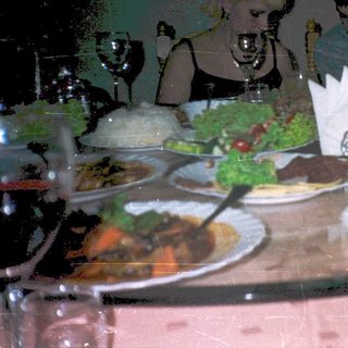 Family dining on diverse meal at festive table.