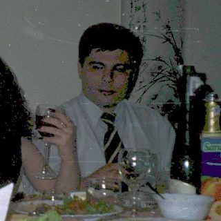 Three people dining together at a table with food and drinks.