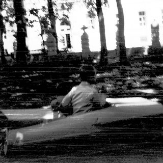 Person sitting alone on park bench.