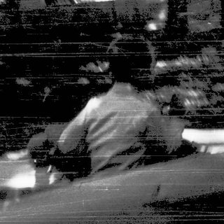 Person sitting alone on park bench.