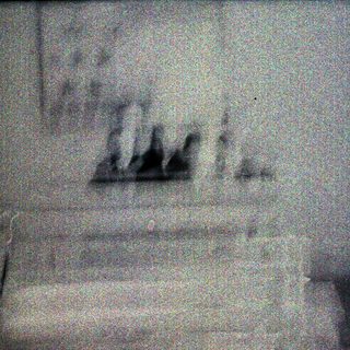 Blurry image of stairs with indistinct figures.