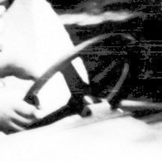 Two children riding a dark indoor log flume ride.