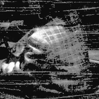 Blurred figure sitting on wooden bench at night.