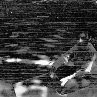 Blurred silhouette of person playing guitar.