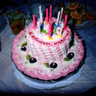 Birthday cake designed like a face with candles.