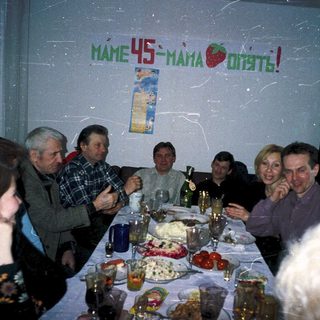 Family gathering celebrating 45th birthday with food and drinks.