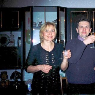 Three people celebrating indoors with champagne glasses.
