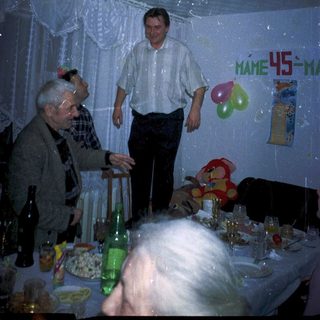 Celebratory birthday party with older guests indoors.