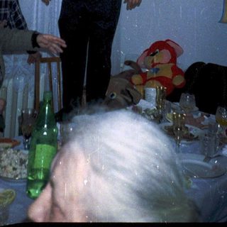 Celebratory birthday party with older guests indoors.