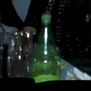 Man celebrating with champagne indoors.