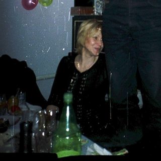 Man celebrating with champagne indoors.