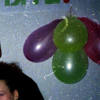 Family celebrating 45th birthday with balloons.