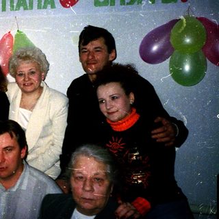 Family celebrating 45th birthday with balloons.