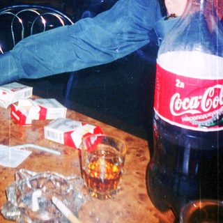 Person appears exhausted at table with drinks and snacks.