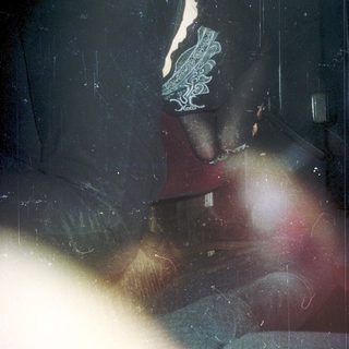 Blurred close-up of person wearing lace sleeve detail.