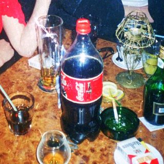 Two people enjoying drinks and conversation indoors.
