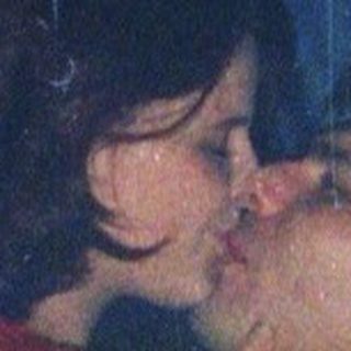 Two people sharing an intimate moment indoors.