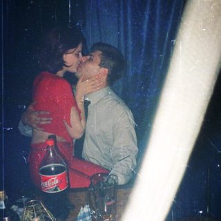 Two people sharing an intimate moment indoors.
