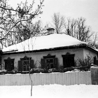 Snow-covered house with classic architecture in winter.