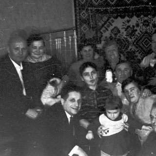 Group posing indoors during early 20th-century gathering.