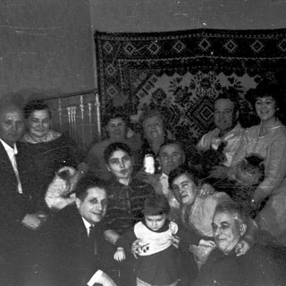 Group posing indoors during early 20th-century gathering.